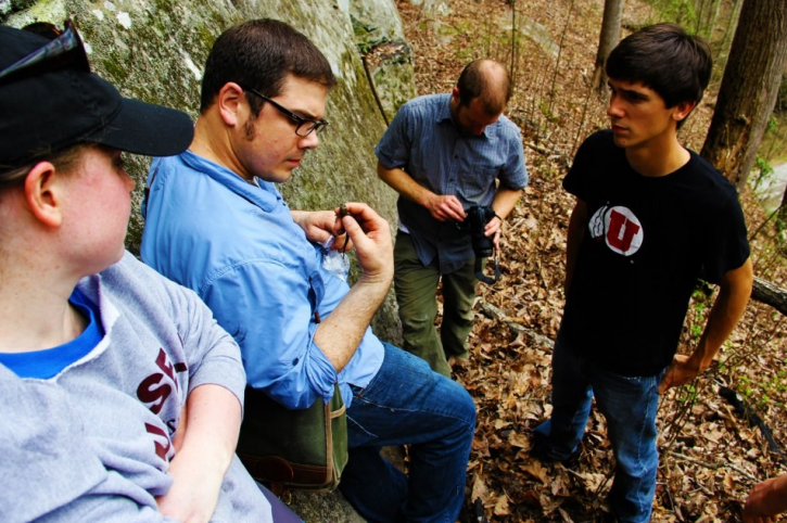 Students measuring a reptile