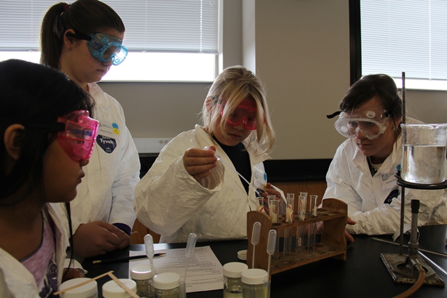A group of girls doing an experiment at the Kentucky Girls STEM Collaborative's "Girls STEM Day" in 2012.