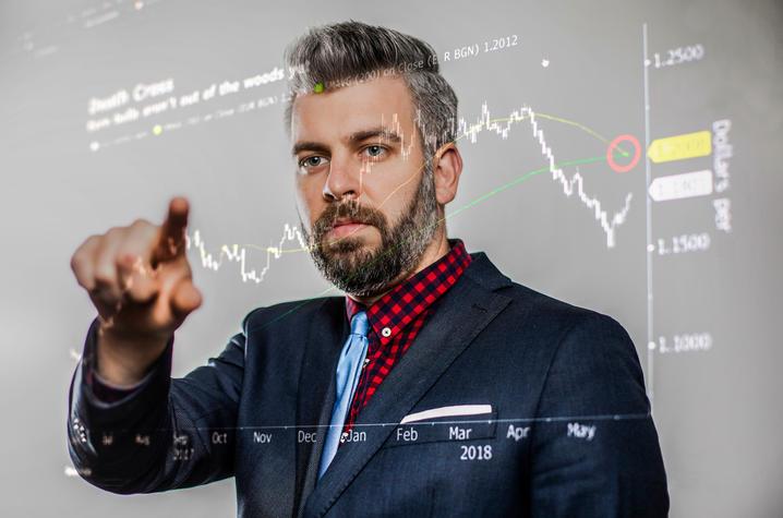 A photo of Michael Zillis behind a graphic board. 