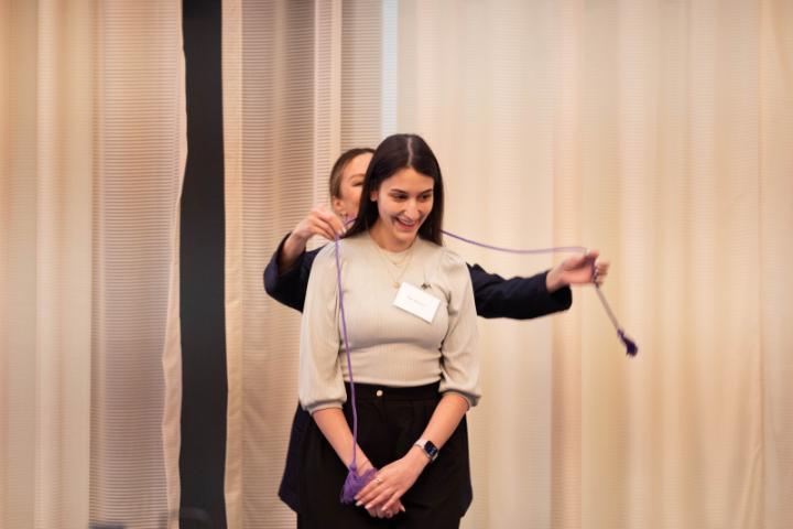 A senior Lunsford Scholar receives their graduation cord