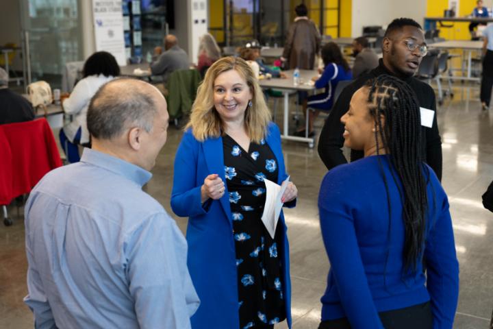 A group mingles with the Dean