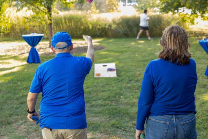 alumni playing cornhole outside