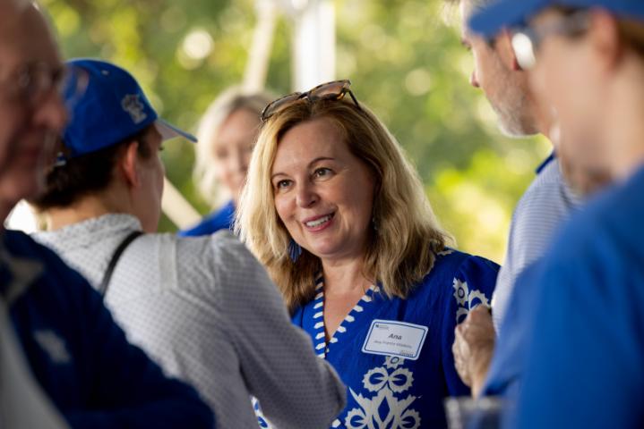dean ana with others smiling and talking