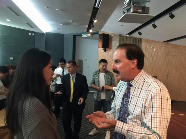 Dean Kornbluh speaking with a student at SICFL.
