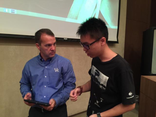 Jesse speaking with a student at Shantou University.