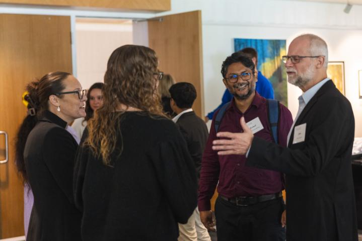 Group of people networking and chatting in lobby.