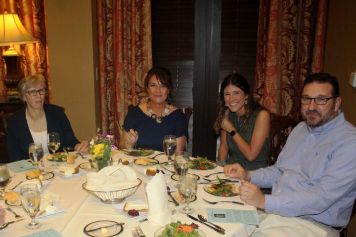 Eva Hicks (at left), who did the lion's share of the work organizing the department's banquet, sits with undergraduate Lauren Greene and her guests.