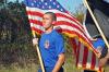 Cadet carries flag during a previous POW/MIA Run