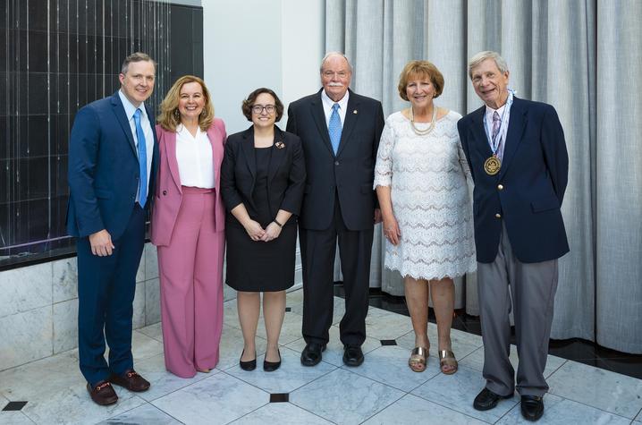 six people line up for a photo