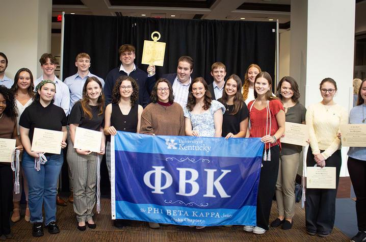 photo of students behind a banner